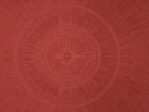 Carta da parati mandala geometrico rosso testurizzato in pietra